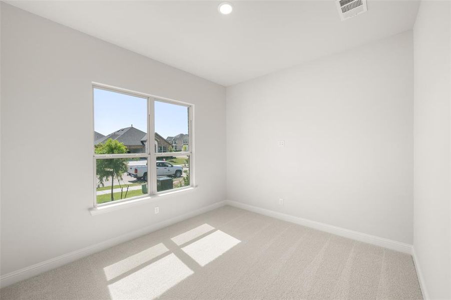 Empty room featuring light carpet and recessed lighting Empty room featuring light carpet and recessed lighting