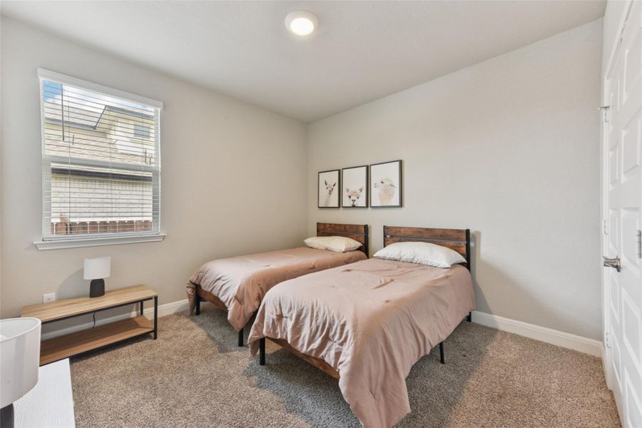 Carpeted bedroom with baseboards Carpeted bedroom with baseboards