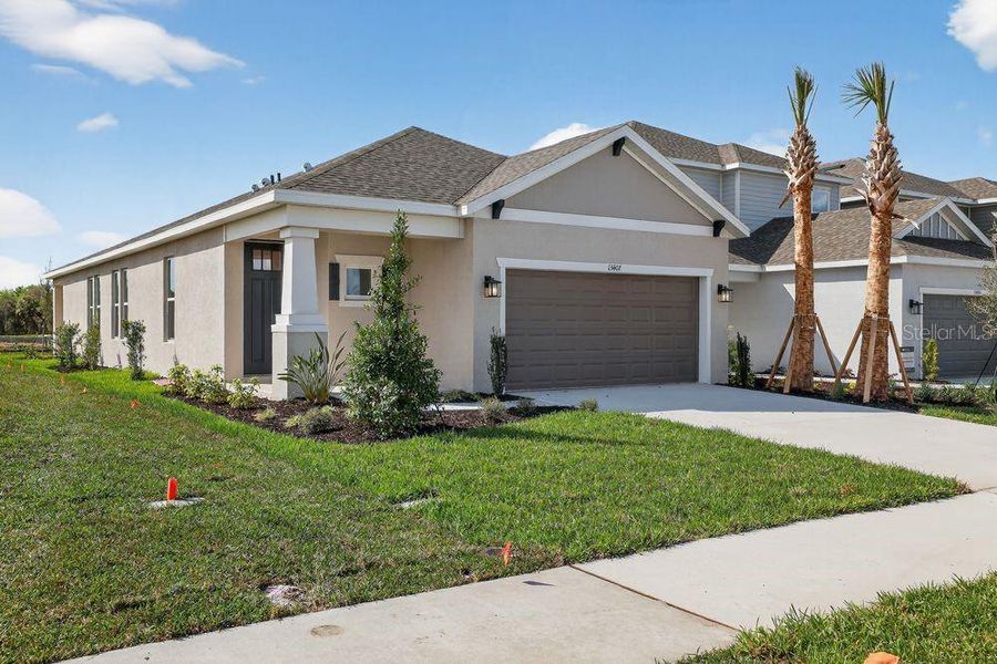 Front exterior of a new home in Firethorn, Parrish, FL, highlighting curb appeal (Image 1). Front exterior of a new home in Firethorn, Parrish, FL, highlighting curb appeal (Image 1).