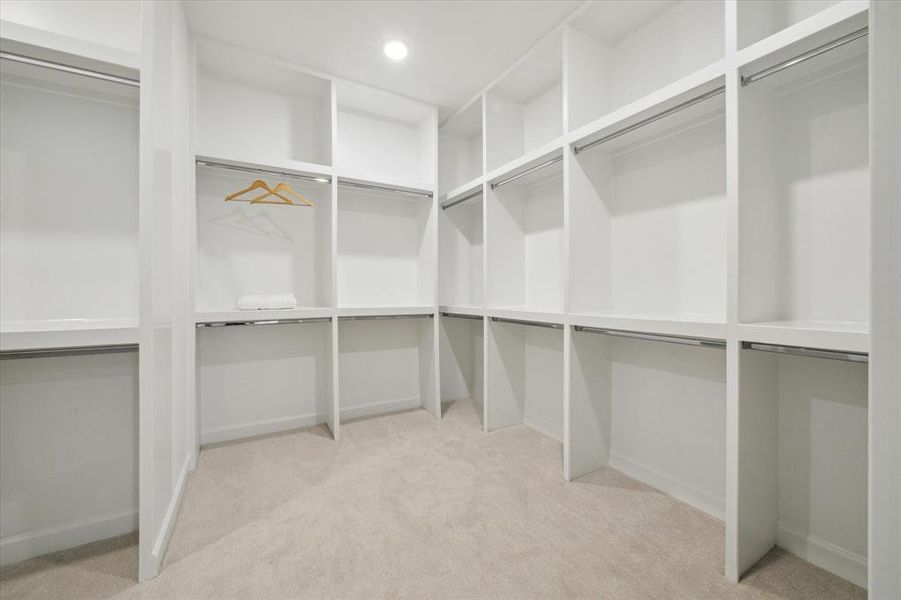 Large primary closet with custombuilt-ins.