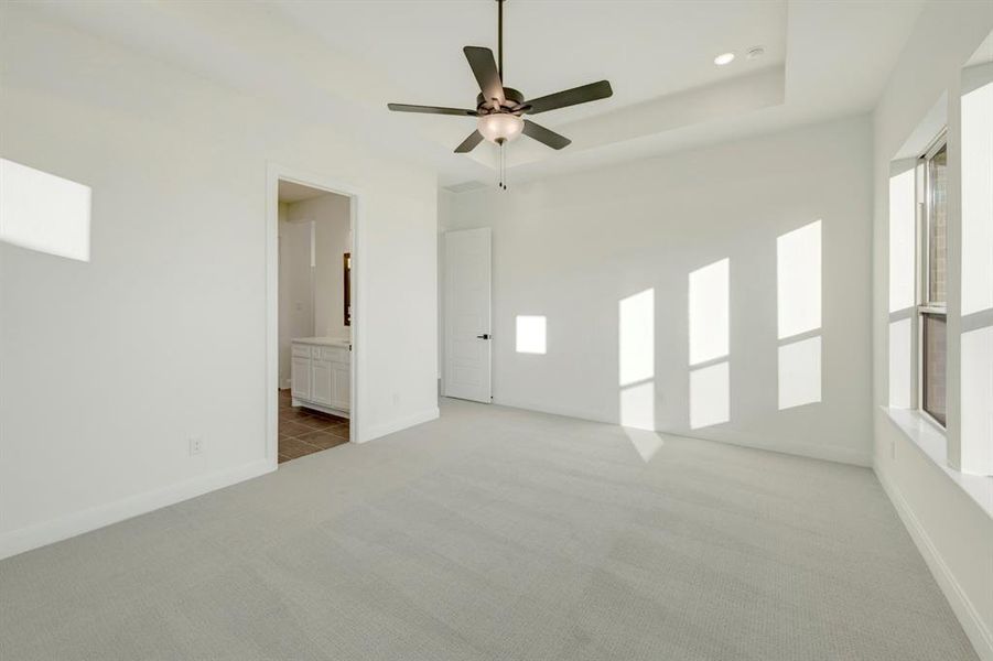 Spare room with light carpet, ceiling fan, recessed lighting, and a raised ceiling Spare room with light carpet, ceiling fan, recessed lighting, and a raised ceiling