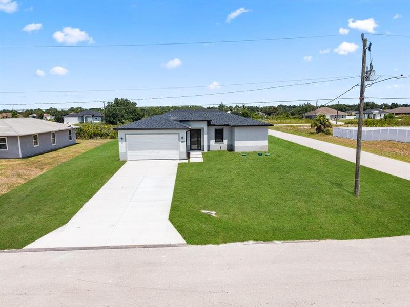 Front exterior of a new home in , Lehigh Acres, FL, highlighting curb appeal (Image 16).