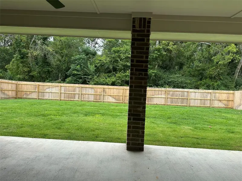 Fenced backyard featuring a patio and a ceiling fan Fenced backyard featuring a patio and a ceiling fan