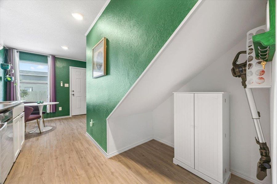 Stairs featuring wood finished floors, a textured wall, and recessed lighting Stairs featuring wood finished floors, a textured wall, and recessed lighting