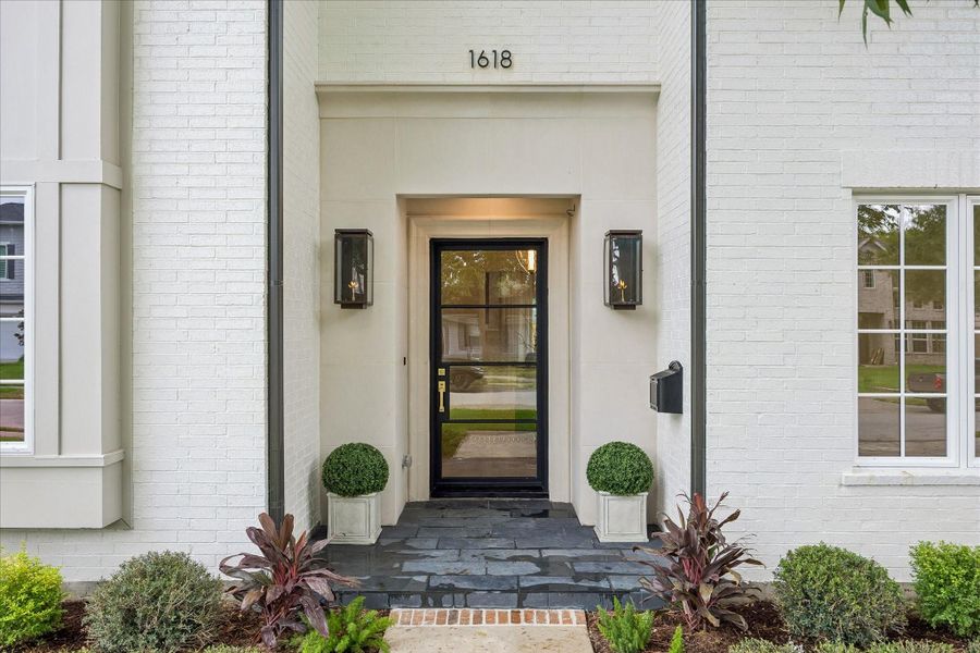 The latest masterpiece by @Northstonebuilders. Welcoming curb appeal with a striking black steel and glass front door, gas lamps