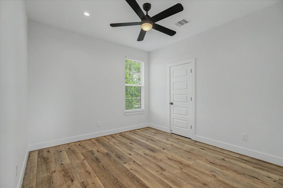 Spacious bedroom featuring recessed can lighting and a remote-controlled ceiling fan.