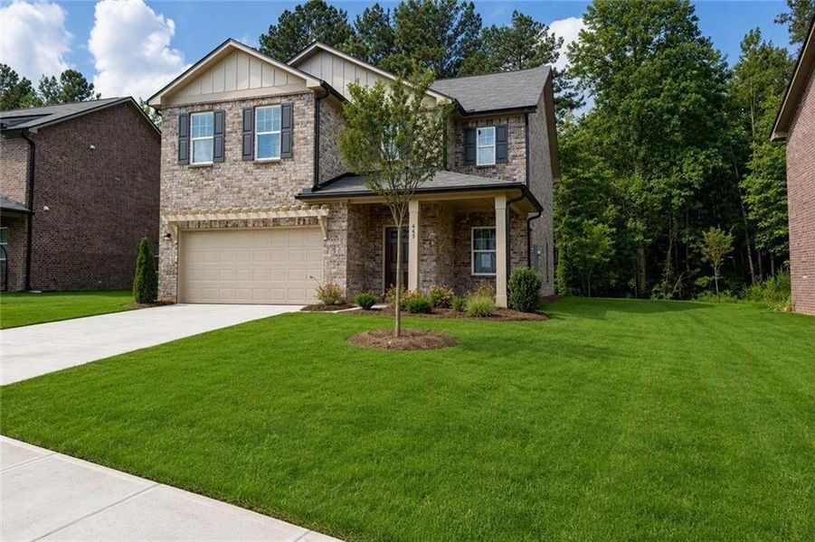 Front exterior of a new home in Kendall Grove, McDonough, GA, highlighting curb appeal (Image 2). Front exterior of a new home in Kendall Grove, McDonough, GA, highlighting curb appeal (Image 2).