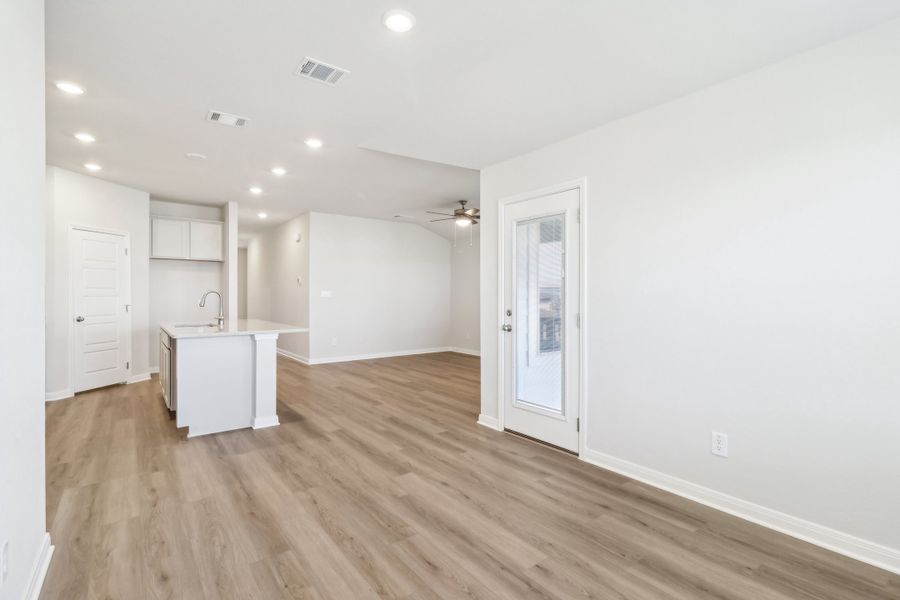 Dining room and kitchen in the Briscoe floorplan at a Meritage Homes community.