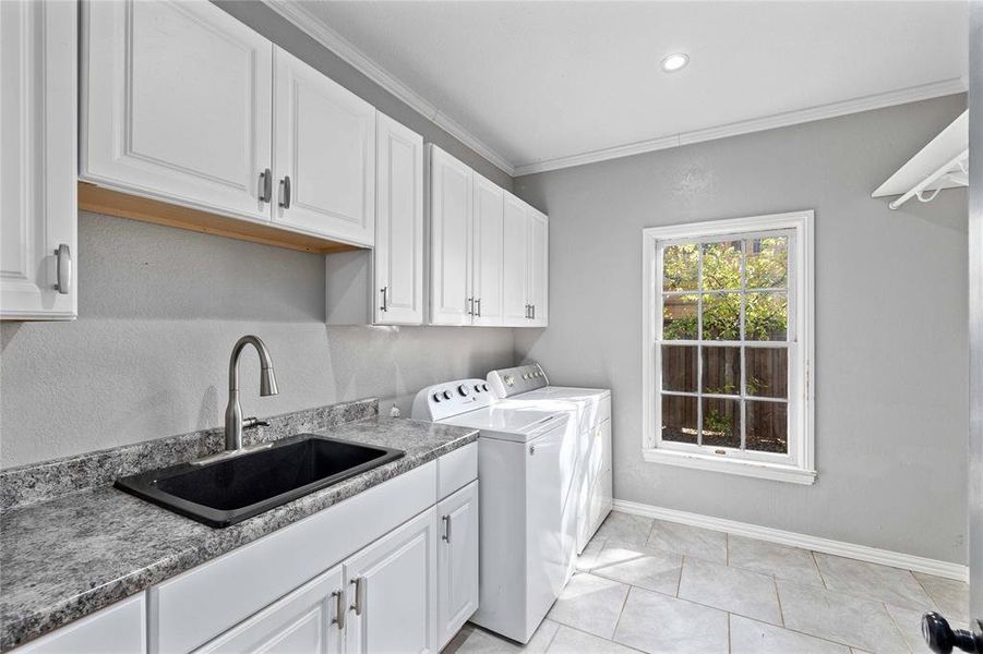 Laundry area with sink and full size washer and dryer hookups