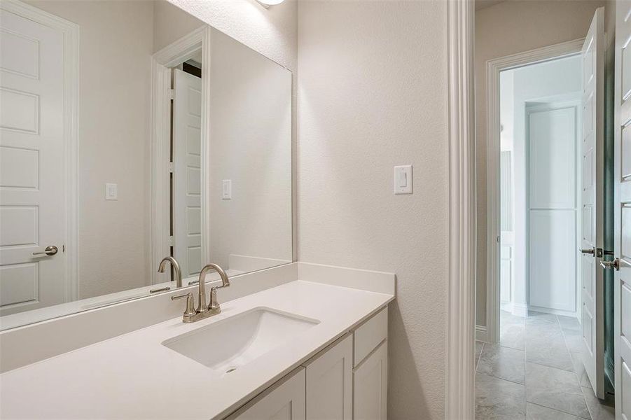 Bathroom featuring vanity and tile patterned floors