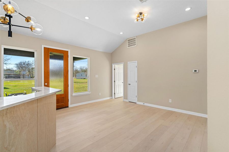 Sunlight streams throughmultiple windows,illuminating the dining nookand offering picturesqueviews of the lush backyard,ideal for indoor-outdoorliving.