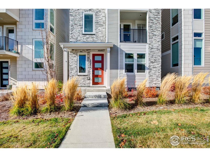 Welcoming front porch with 8' entry door stacked stone highlights