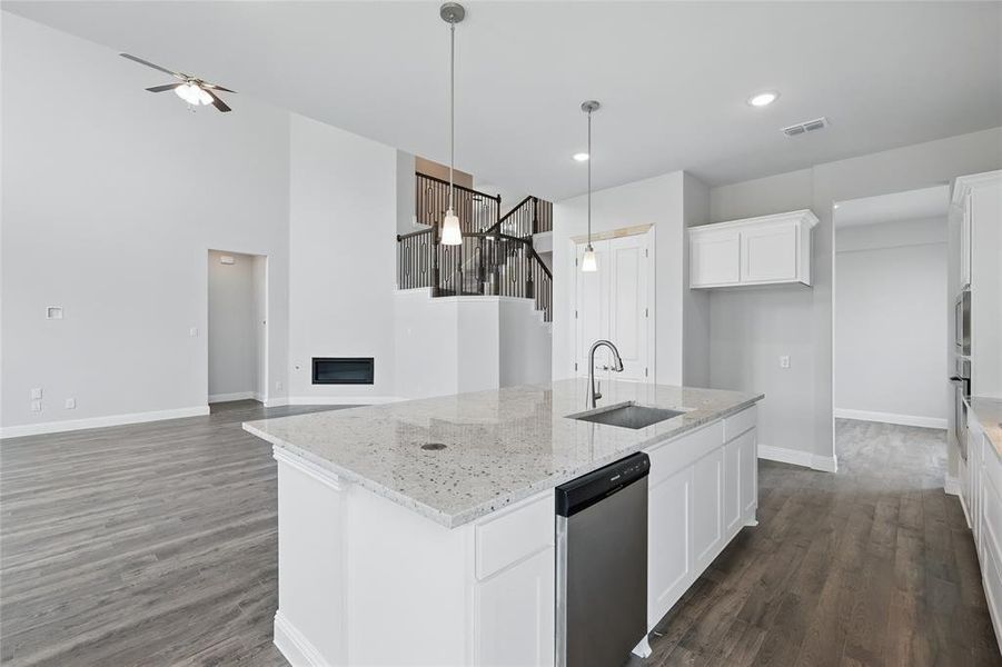 Kitchen featuring a sink, baseboards, dark wood-style flooring, ceiling fan, and a high ceiling Kitchen featuring a sink, baseboards, dark wood-style flooring, ceiling fan, and a high ceiling