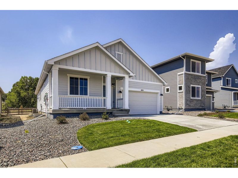 Front exterior of a new home in Trevenna, Windsor, CO, highlighting curb appeal (Image 2). Front exterior of a new home in Trevenna, Windsor, CO, highlighting curb appeal (Image 2).