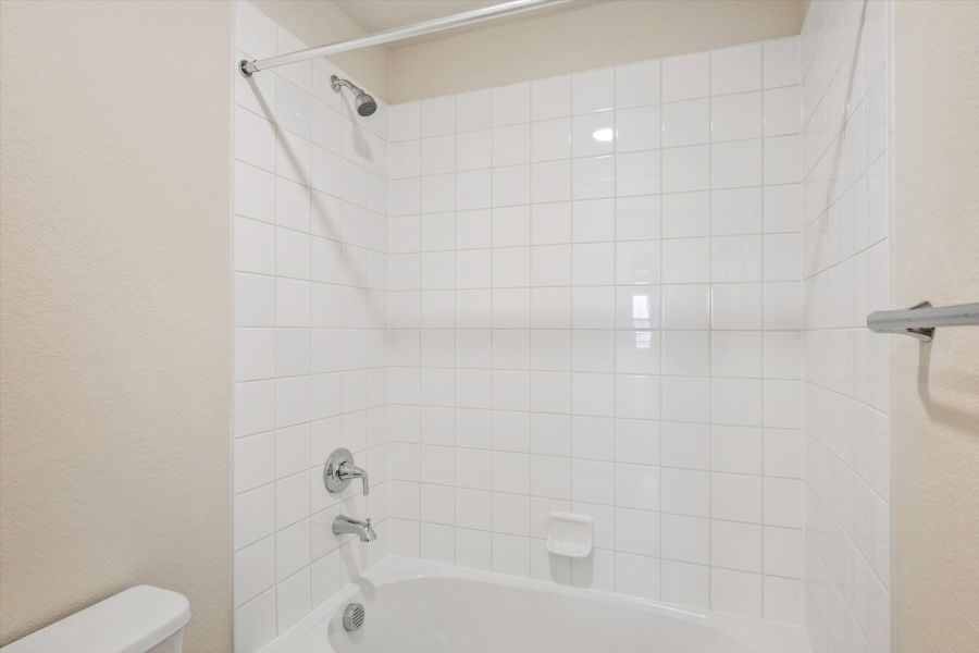 A white tiled bathroom.