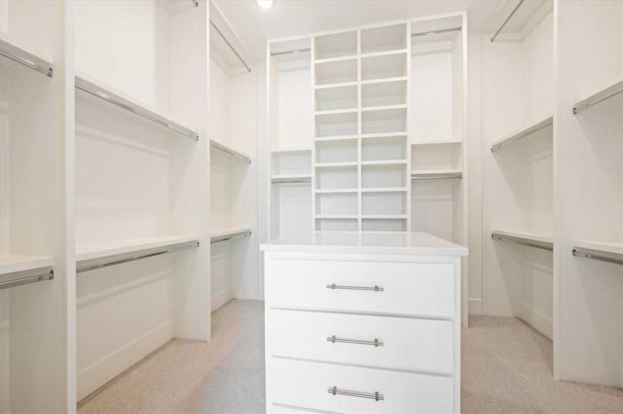 Walk in closet featuring light colored carpet