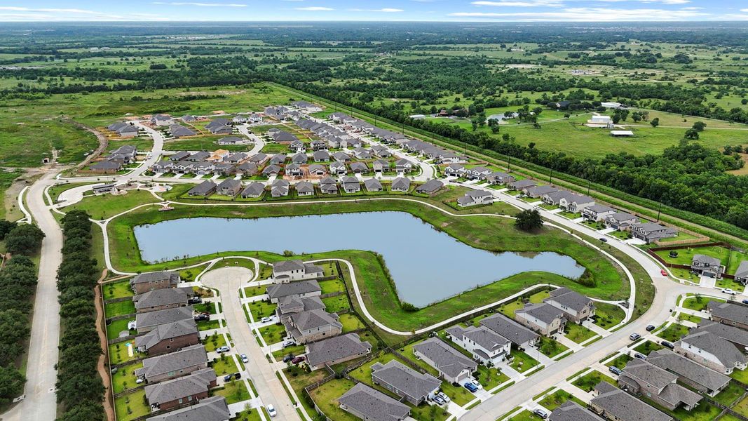 Aerial view of the Massey Oaks community reveals oak tree-lined streets, sparkling lakes, and thoughtfully designed homes surrounded by natural beauty. Aerial view of the Massey Oaks community reveals oak tree-lined streets, sparkling lakes, and thoughtfully designed homes surrounded by natural beauty.