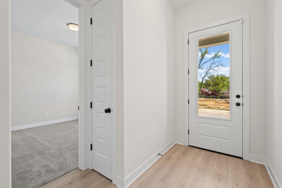 Doorway to outside with baseboards and wood finished floors
