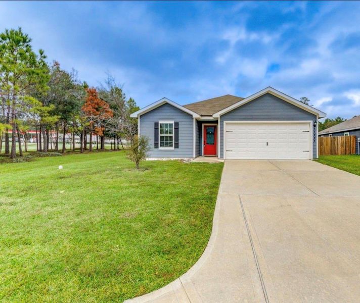 Front exterior of a new home in Williams Trace, Magnolia, TX, highlighting curb appeal (Image 25).