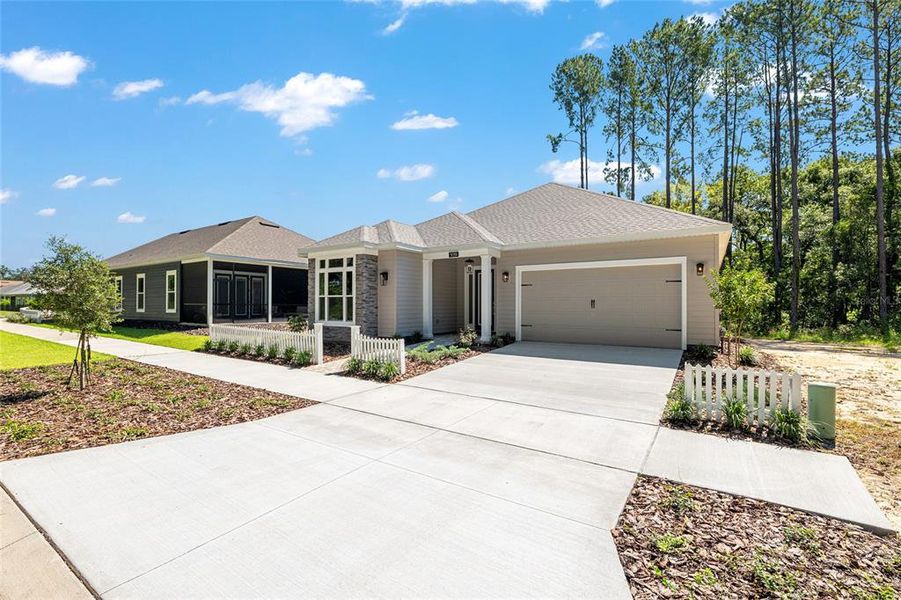 Front exterior of a new home in Fairway Pointe at West End, Newberry, FL, highlighting curb appeal (Image 29). Front exterior of a new home in Fairway Pointe at West End, Newberry, FL, highlighting curb appeal (Image 29).