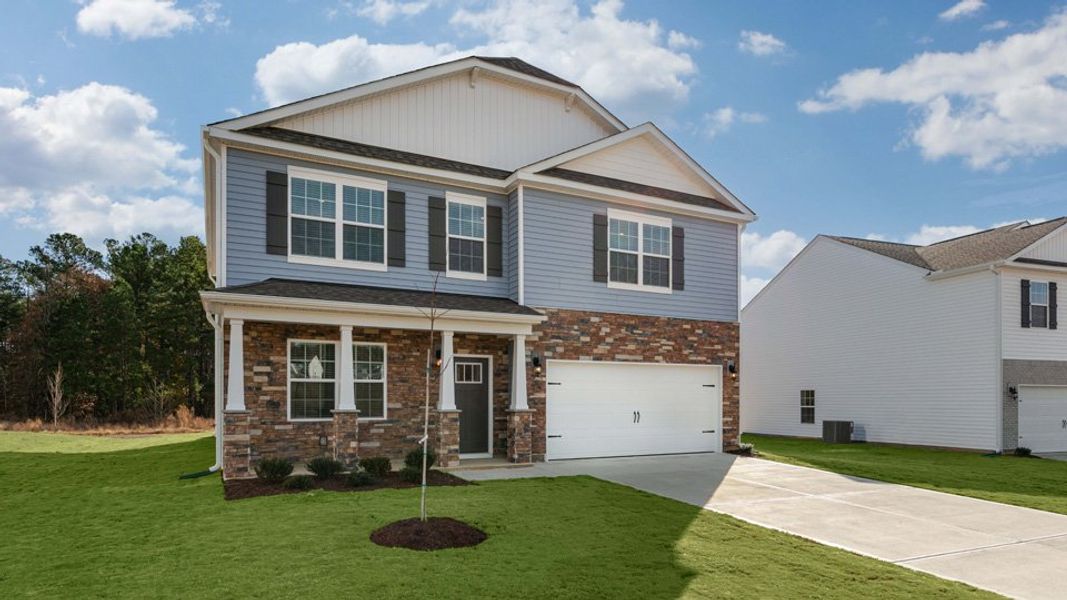 Front exterior of a new home in Shahbain Reserve, Raeford, NC, highlighting curb appeal (Image 16). Front exterior of a new home in Shahbain Reserve, Raeford, NC, highlighting curb appeal (Image 16).