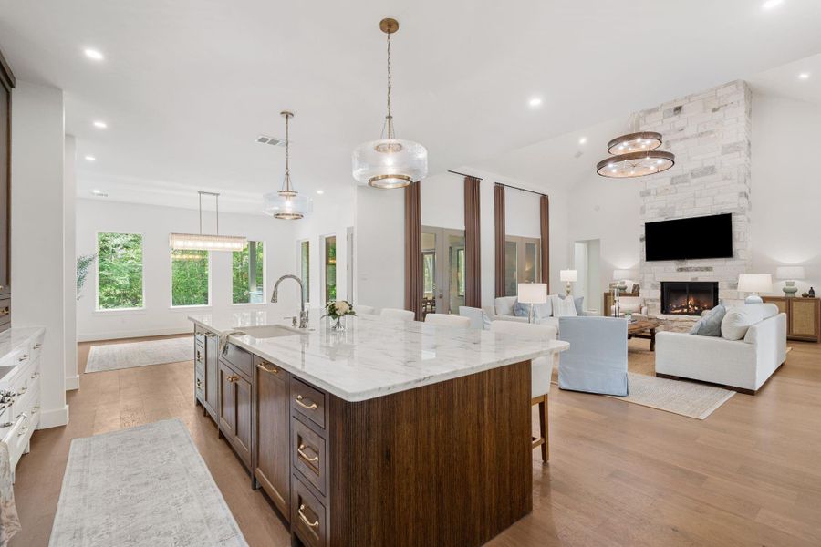 An open sightline to the custom cabinetry and expansive island keeps the entire main area connected and impressive