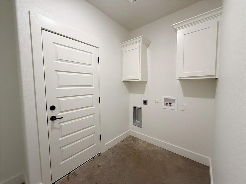 Washroom featuring hookup for an electric dryer, hookup for a gas dryer, washer hookup, and cabinet space