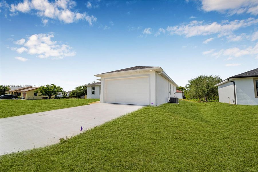 Front exterior of a new home in , Lehigh Acres, FL, highlighting curb appeal (Image 19). Front exterior of a new home in , Lehigh Acres, FL, highlighting curb appeal (Image 19).