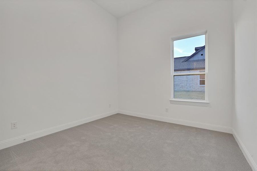 Bedroom with light carpet and vaulted ceiling