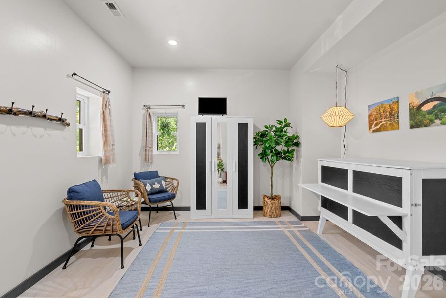 Flooring in the studio apartment is padded Laminate plank flooring over concrete.