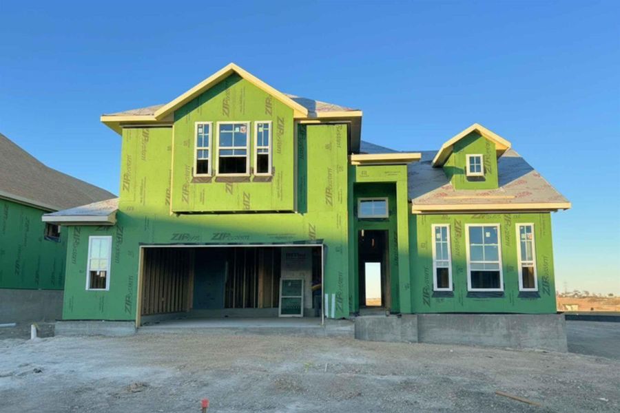 Property under construction with an attached garage and driveway