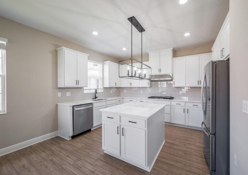 A white kitchen with beautiful backsplash.