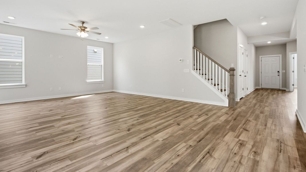 First floor with hard surface flooring, windows, and nearby staircase First floor with hard surface flooring, windows, and nearby staircase