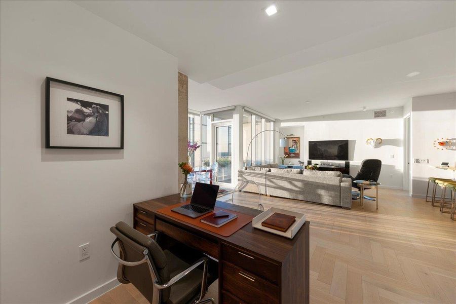 A naturally lit flexible space that opens directly to the living and dining areas, ideal as a home office, creative studio or private library. The upgraded herringbone wood floors and clean architectural lines make it a refined extension of the residence’s custom, penthouse-level design.