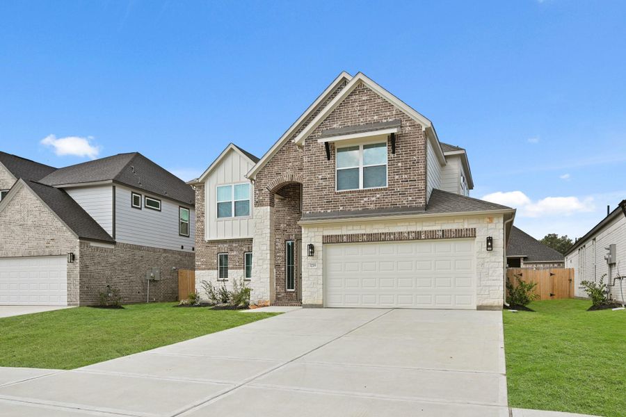 Front exterior of a new home in Barton Creek Ranch, Conroe, TX, highlighting curb appeal (Image 18). Front exterior of a new home in Barton Creek Ranch, Conroe, TX, highlighting curb appeal (Image 18).