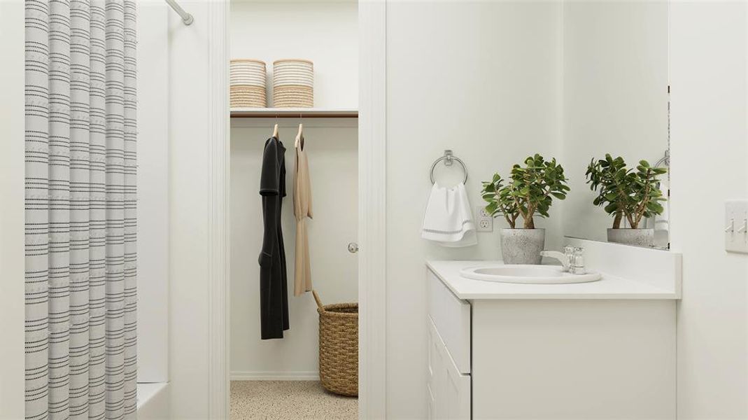 Bathroom featuring vanity and shower / bath combination with curtain