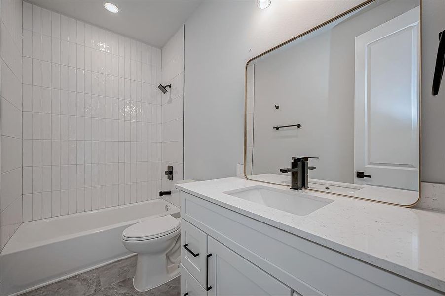 This modern bathroom features a sleek white vanity with a large mirror, a bathtub with white tile surround, and contemporary fixtures. Perfect for a fresh, clean look.