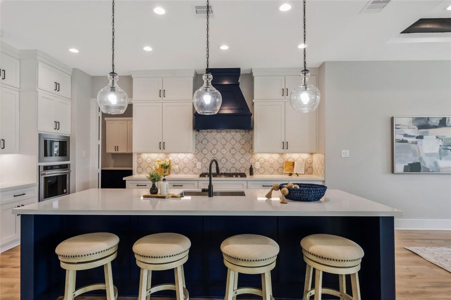 Spacious kitchen island with ample seating, perfect for gatherings.