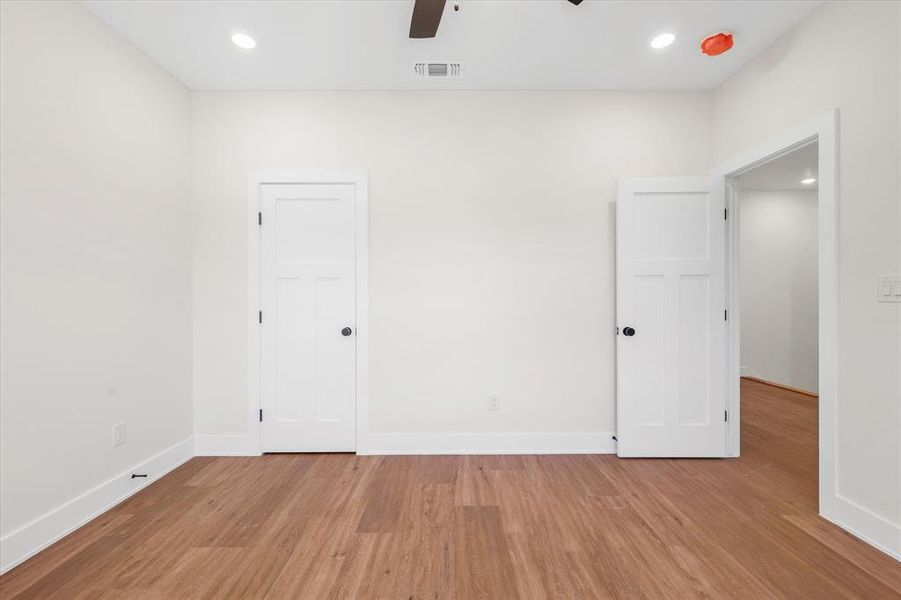 Spare room with light wood-style floors, a ceiling fan, and recessed lighting