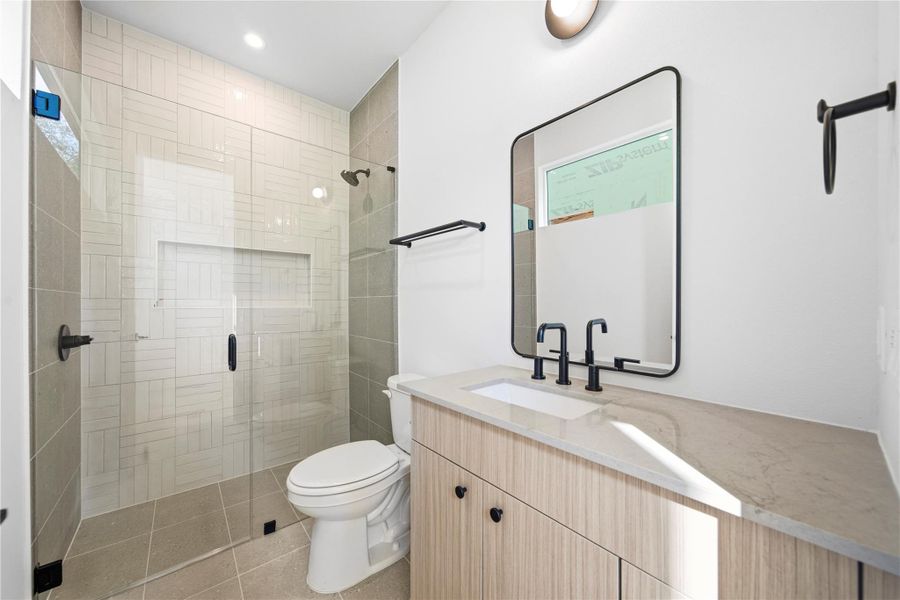 Bathroom featuring vanity, a shower stall, and light tile patterned flooring Bathroom featuring vanity, a shower stall, and light tile patterned flooring