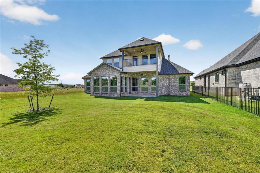 Expansive backyard featuring a manicured lawn