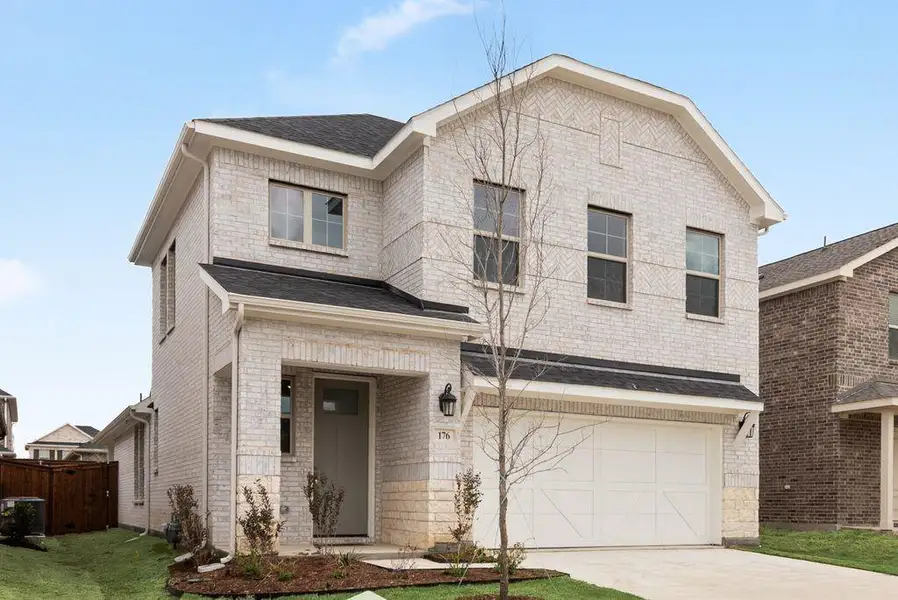 Front exterior of a new home in Spiritas Ranch, Little Elm, TX, highlighting curb appeal (Image 20).