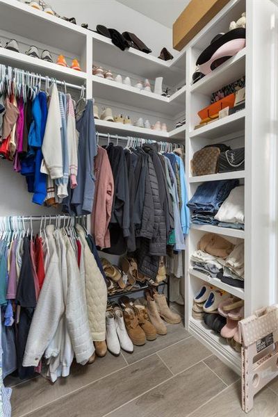 Walk in closet with wood tiled floors Walk in closet with wood tiled floors