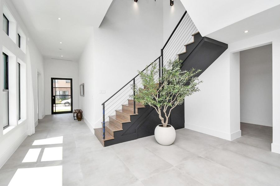Stairs feature premium wood flooring with iron stair railing. Stairs feature premium wood flooring with iron stair railing.