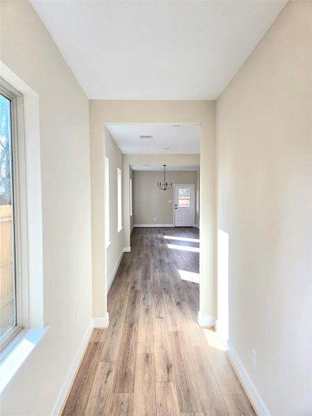 Hallway leading to open concept living/kitchen area Hallway leading to open concept living/kitchen area
