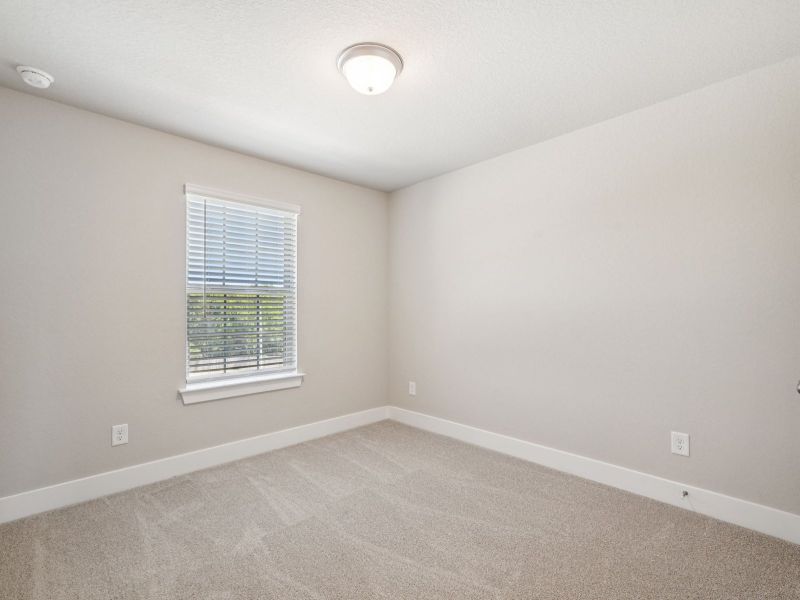 Guest bedroom in the Red River floorplan at a Meritage Homes community.
