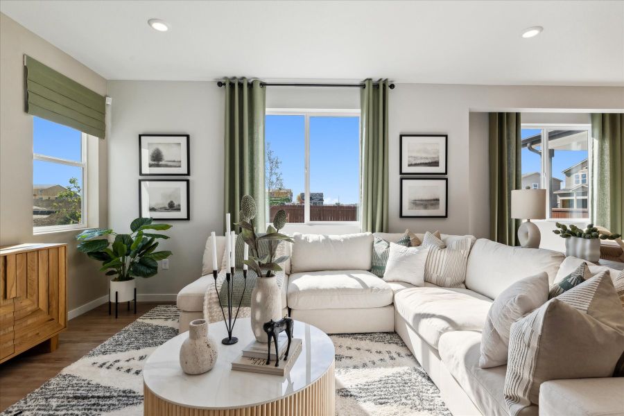 A living room with a couch and a table. A living room with a couch and a table.