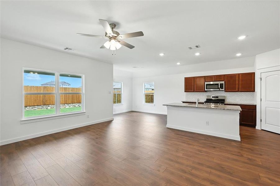 Kitchen featuring appliances with stainless steel finishes, open floor plan, recessed lighting, plenty of natural light, and ceiling fan Kitchen featuring appliances with stainless steel finishes, open floor plan, recessed lighting, plenty of natural light, and ceiling fan