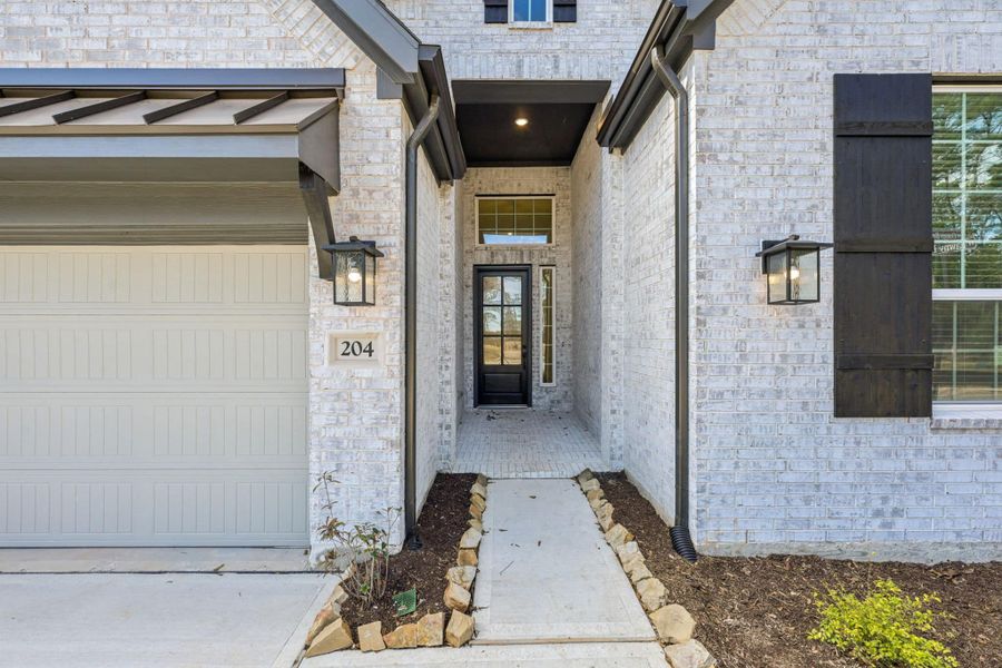 Exterior details and patio area of a home in The Woodlands Hills, Willis (Image 3).