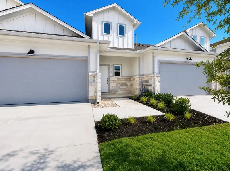 Front exterior of a new home in Wellspring, Round Rock, TX, highlighting curb appeal (Image 18).